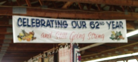banner sign hanging from the rafters "Celebrating out 62nd Year and Still Going Strong"